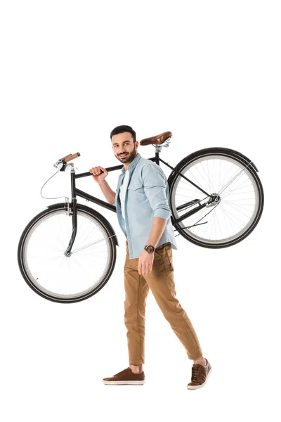 Homem bonito em camisa azul e calças bege segurando bicicleta isolada em branco — Fotografia de Stock