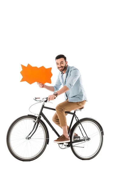Happy handsome man riding bicycle while holding thought bubble isolated on white — Stock Photo