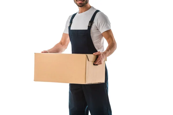 Cropped view of delivery man in overalls holding carton box isolated on white — Stock Photo