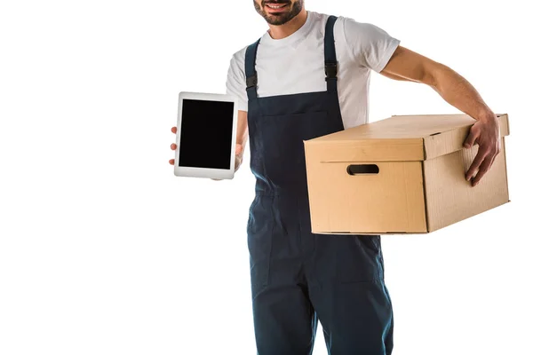 Partial view of delivery man with carton box holding digital tablet with blank screen isolated on white — Stock Photo