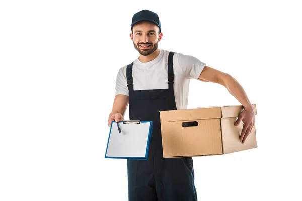 Handsome smiling delivery man with cardboard box holding clipboard with blank paper and looking at camera isolated on white — Stock Photo