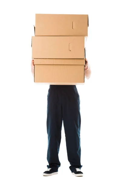 Partial view of delivery man hiding behind cardboard boxes isolated on white — Stock Photo