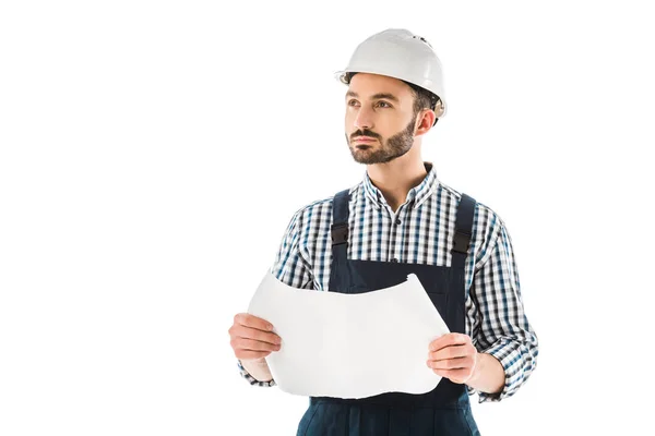 Thoughtful construction worker holding building plan and looking up isolated on white — Stock Photo