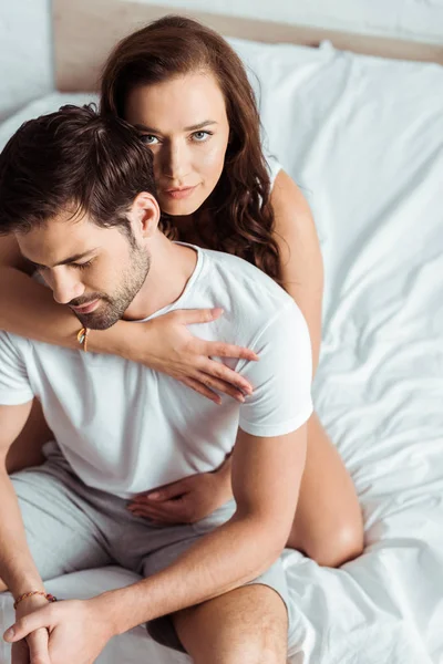 Overhead view of woman hugging handsome man in bedroom — Stock Photo