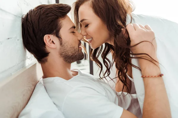 Happy young woman with closed eyes near cheerful boyfriend — Stock Photo