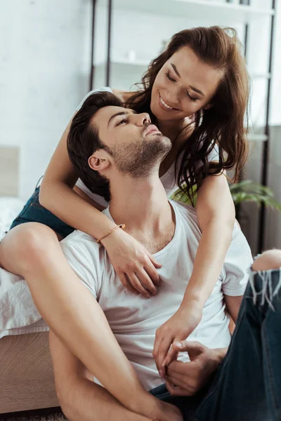 Happy brunette girl looking at handsome man while holding hands — Stock Photo