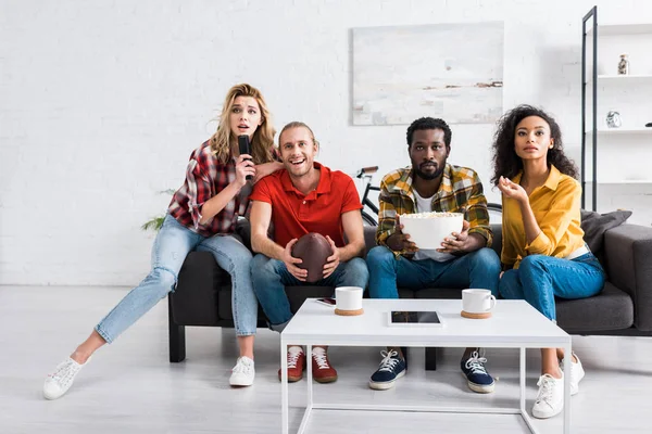 Excited multicultural men and women watching championship and spending time together — Stock Photo