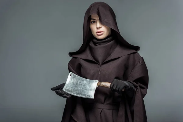 Woman in death costume holding cleaver isolated on grey — Stock Photo