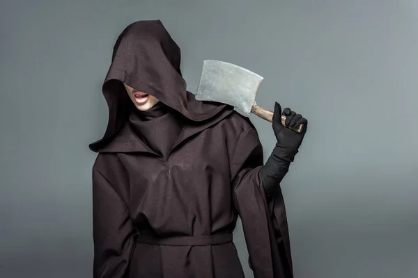 Woman in death costume holding cleaver isolated on grey — Stock Photo