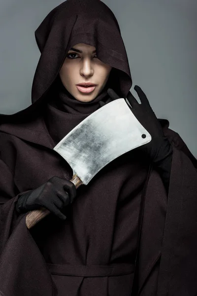 Woman in death costume holding cleaver isolated on grey — Stock Photo