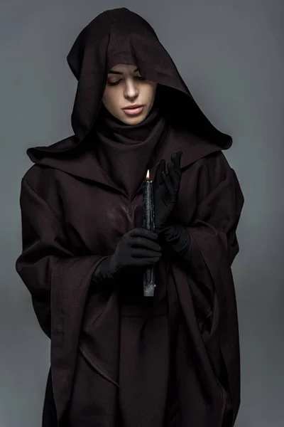 Woman in death costume holding burning candle isolated on grey — Stock Photo