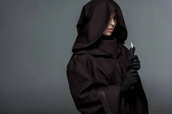 Woman in death costume holding burning candle isolated on grey — Stock Photo