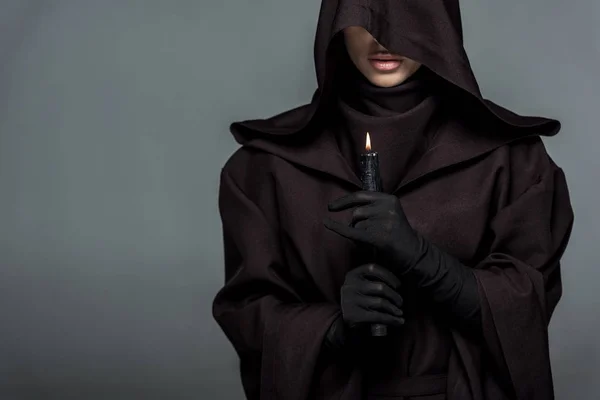 Partial view of woman in death costume holding burning candle isolated on grey — Stock Photo