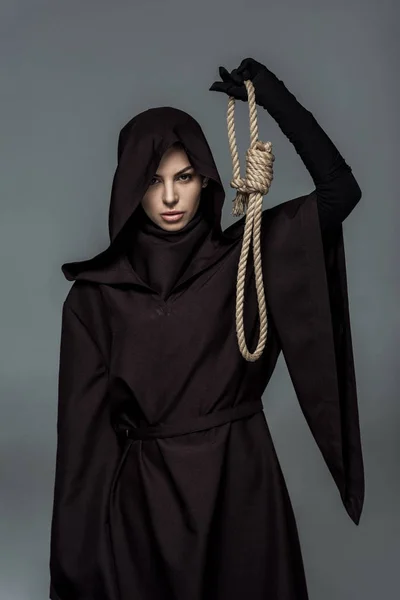 Woman in death costume holding hanging noose isolated on grey — Stock Photo