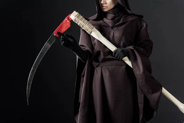 Cropped view of woman in death costume holding scythe on black — Stock Photo