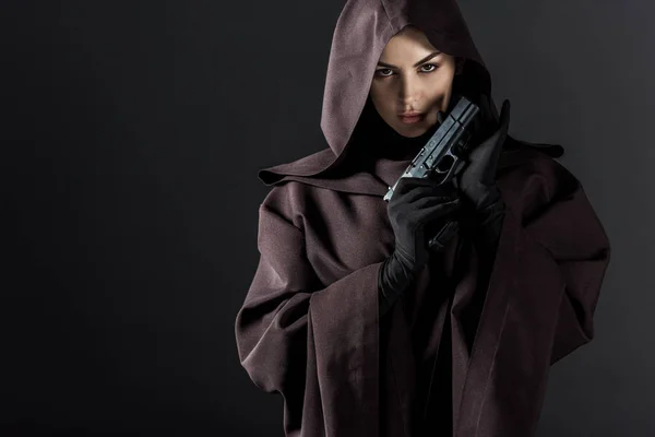 Woman in death costume holding gun isolated on black — Stock Photo