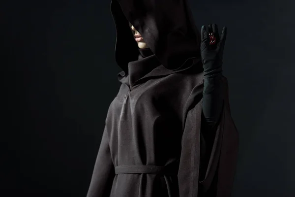 Cropped view of woman in death costume holding dice isolated on black — Stock Photo