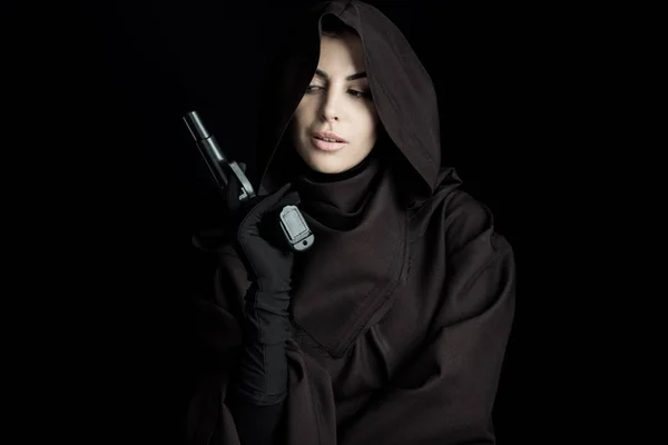 Beautiful woman in death costume holding gun isolated on black — Stock Photo