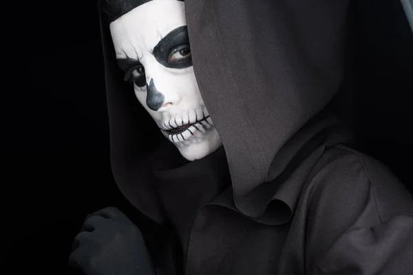 Woman with skull makeup looking at camera isolated on black — Stock Photo