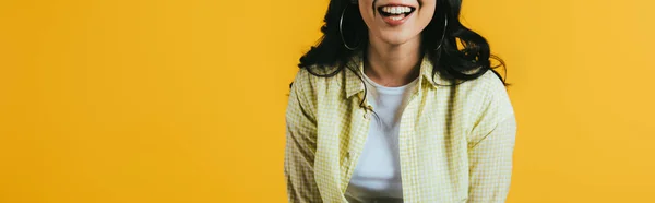 Обрізаний вид усміхненої брюнетки дівчина ізольована на жовтому — стокове фото