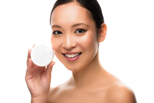 Hermosa chica asiática sosteniendo crema cosmética, aislado en blanco - foto de stock