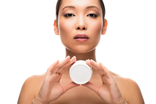 Attractive asian woman holding face cream, isolated on white — Stock Photo