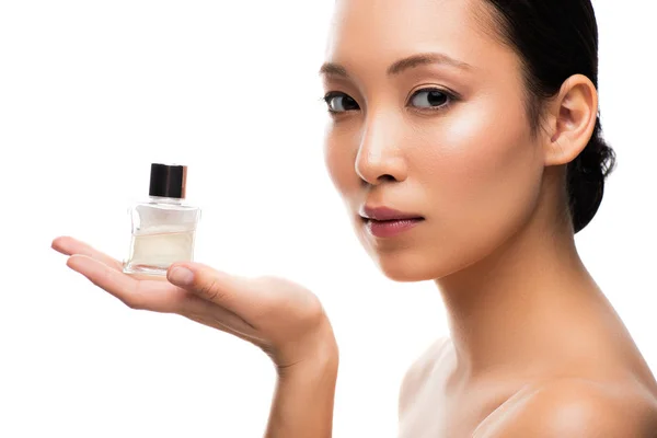 Attractive asian woman holding perfume, isolated on white — Stock Photo