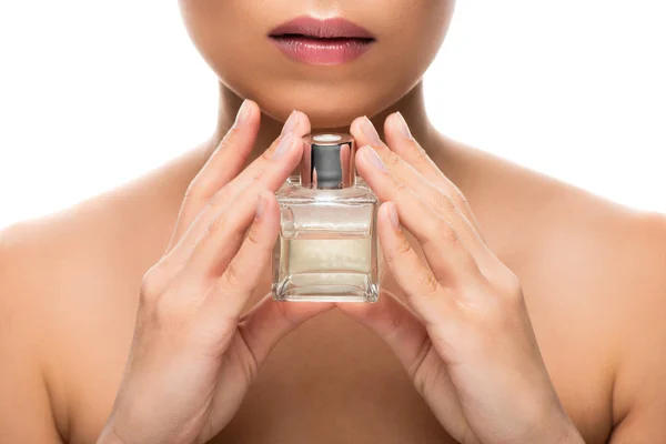 Vista recortada de la mujer tierna con los ojos cerrados sosteniendo frasco de perfume, aislado en blanco — Stock Photo