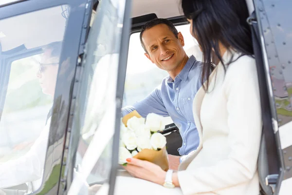 Husband and wife sitting in helicopter on romantic date — Stock Photo