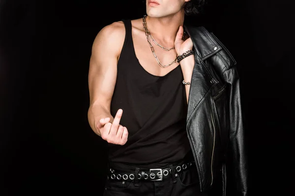 Cropped view of man showing middle finger and holding leather jacket isolated on black — Stock Photo