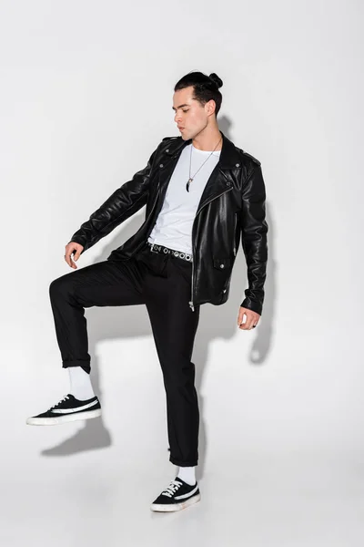 Handsome and stylish man in leather jacket posing on white — Stock Photo