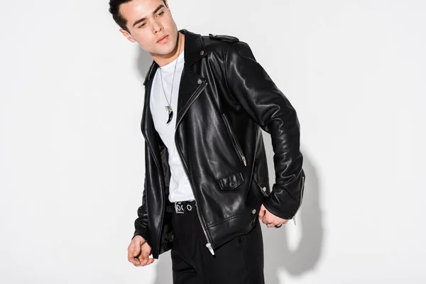 Stylish man in leather jacket standing on white — Stock Photo