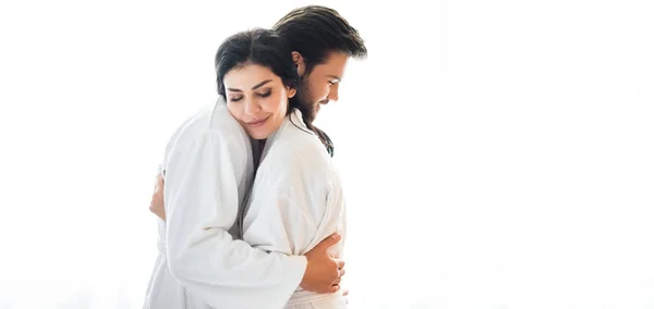 Panoramic shot of happy man and woman hugging in hotel room — Stock Photo