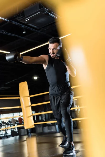 Selective focus of strong bearded man boxing in sports center — Stock Photo