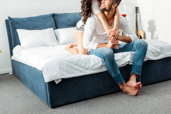 Cropped view of boyfriend and girlfriend gently embracing in bed at morning — Stock Photo