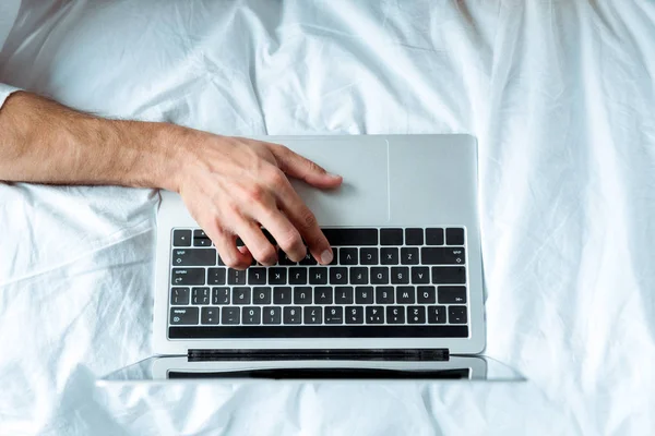 Top view of man typing on laptop keyboard, illustrative editorial — Stock Photo