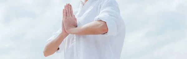 Panoramic shot of young woman with praying hands near sky — Stock Photo