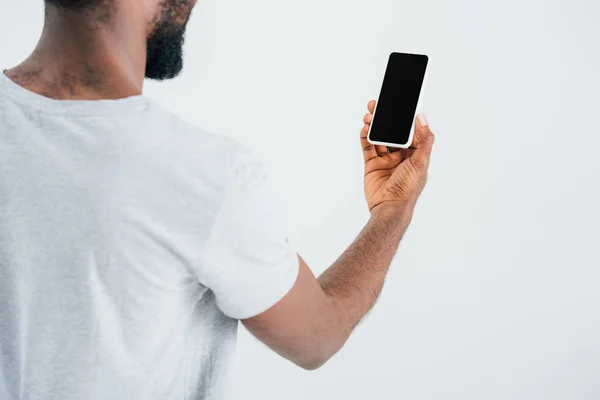 Vista ritagliata di uomo afroamericano utilizzando smartphone con schermo bianco, isolato su grigio — Foto stock