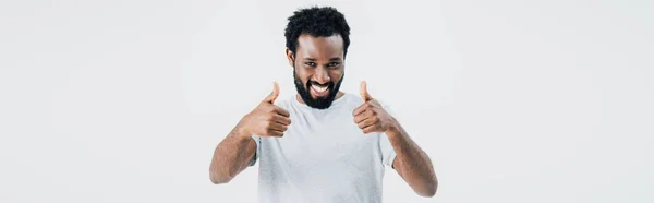 Cheerful african american man in grey t-shirt showing thumbs up isolated on grey — Stock Photo