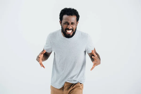 Агресивний афроамериканський чоловік у сірій футболці позує ізольовано на сірому — стокове фото