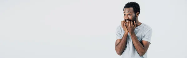 Stressed african american man in grey t-shirt, isolated on grey — Stock Photo