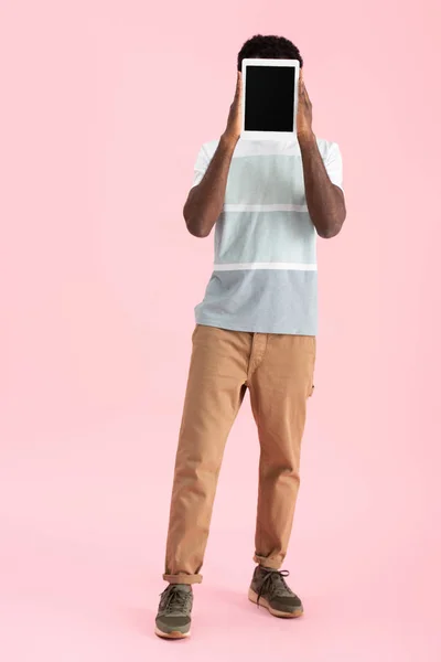 African american man showing digital tablet with blank screen isolated on pink — Stock Photo