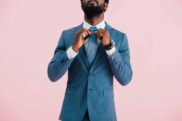 Vista recortada de hombre de negocios afroamericano en traje y corbata, aislado en rosa - foto de stock