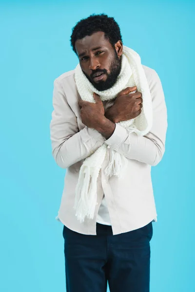 Афроамериканський чоловік у теплому шарфі має холод, ізольований на синьому — стокове фото