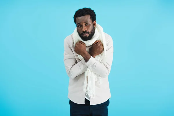 Sick african american man in warm scarf, isolated on blue — Stock Photo