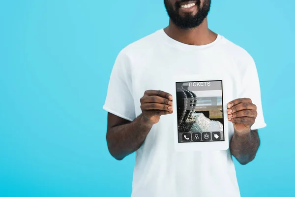 Cropped view of african american man showing digital tablet with tickets app, isolated on blue — Stock Photo