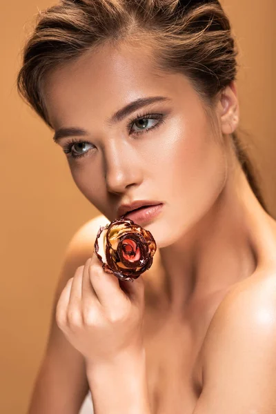 Young beautiful naked woman with shiny makeup isolated on beige — Stock Photo