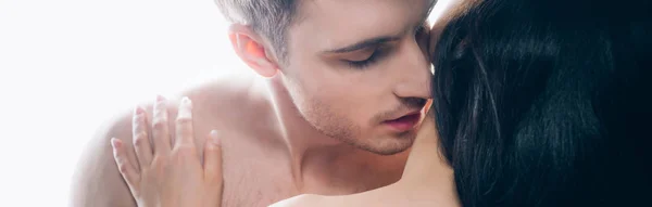 Panoramic shot of young man passionately kissing woman neck isolated on white — Stock Photo