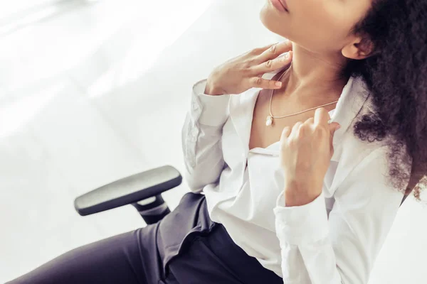 Cropped view of african american businesswoman suffering from summer heat in office — Stock Photo