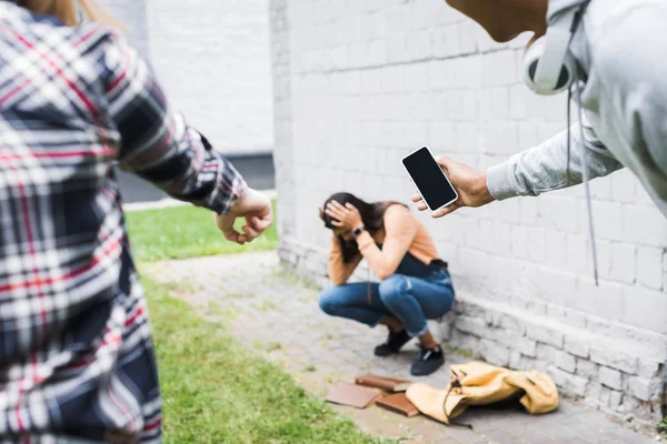 Partial view of african american boy and teenager pointing with finger and shooting scared teenager — Stock Photo